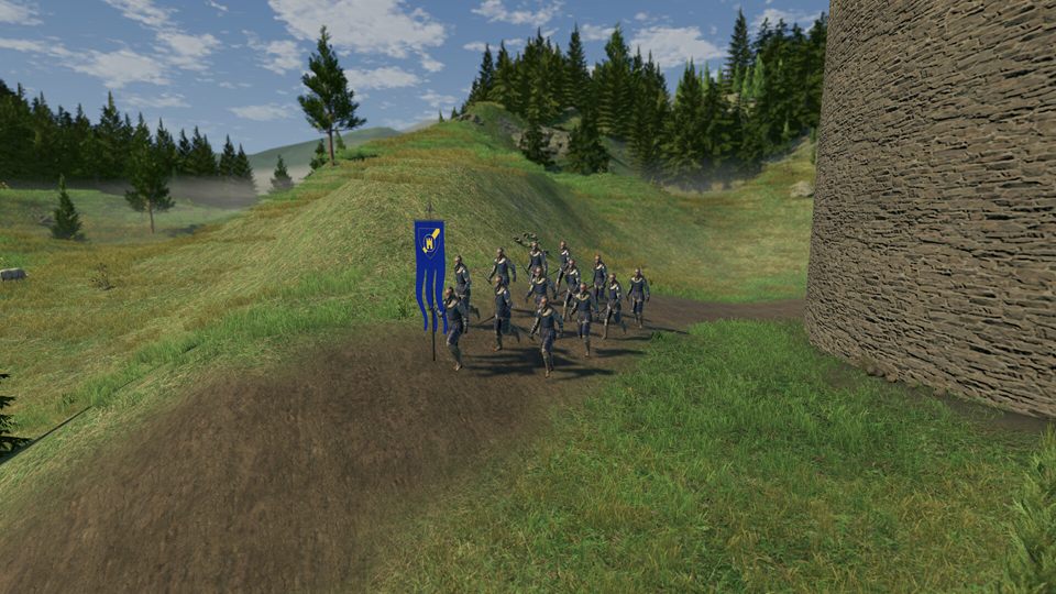 Screenshot: a company of soldiers following a blue banner along a dirt path beside a round stone tower