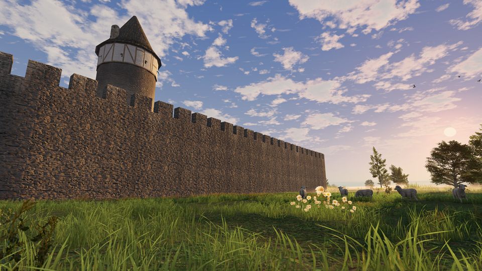 Screenshot: a long crenellated curtain wall with a half-timbered tower under an evening sky, sheep in the meadow